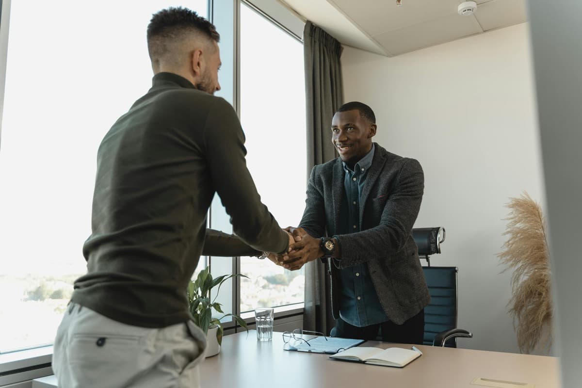 Un jeune professionnel souriant lors d'un entretien d'embauche — recruter dans son quartier à Douala